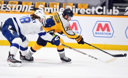 Feb 8, 2021; Nashville, Tennessee, USA; Nashville Predators right wing Viktor Arvidsson (33) attempts a shot with pressure from Tampa Bay Lightning defenseman Mikhail Sergachev (98) during the first period at Bridgestone Arena. Mandatory Credit: Christopher Hanewinckel-USA TODAY Sports