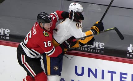 Apr 21, 2021; Chicago, Illinois, USA; Chicago Blackhawks defenseman Nikita Zadorov (16) checks Nashville Predators center Ryan Johansen (92) during the second period at the United Center. Mandatory Credit: Mike Dinovo-USA TODAY Sports
