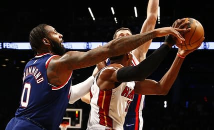 Mar 3, 2022; Brooklyn, New York, USA; Miami Heat center Bam Adebayo (13) controls the ball while being defended by Brooklyn Nets center Andre Drummond (0) during the first half at Barclays Center. Mandatory Credit: Andy Marlin-USA TODAY Sports