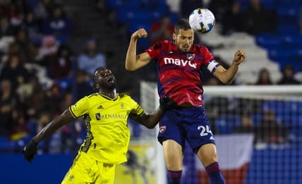 Mar 12, 2022; Frisco, Texas, USA;  FC Dallas defender Matt Hedges (24) heads the ball away from Nashville SC forward C.J. Sapong (17) during the first half at Toyota Stadium. Mandatory Credit: Kevin Jairaj-USA TODAY Sports
