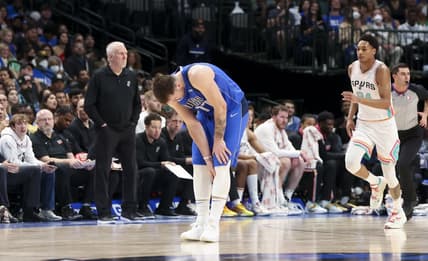Apr 10, 2022; Dallas, Texas, USA; Dallas Mavericks guard Luka Doncic (77) grabs his left calf during the second half against the San Antonio Spurs at American Airlines Center. Mandatory Credit: Kevin Jairaj-USA TODAY Sports