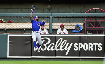 Jun 24, 2022; St. Louis, Missouri, USA;  Chicago Cubs right fielder Jason Heyward (22) leaps and catches a fly ball against the St. Louis Cardinals during the second inning at Busch Stadium. Mandatory Credit: Jeff Curry-USA TODAY Sports