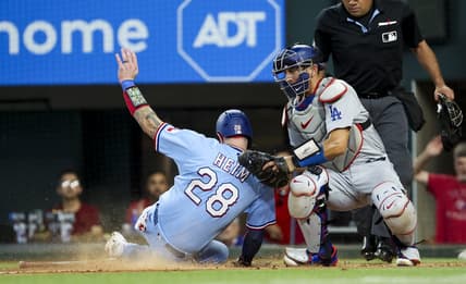 Jul 23, 2023; Arlington, Texas, USA;  Texas Rangers catcher Jonah Heim (28) scores ahead of the tag by Los Angeles Dodgers catcher Austin Barnes (15) during the fourth inning at Globe Life Field. Mandatory Credit: Kevin Jairaj-USA TODAY Sports