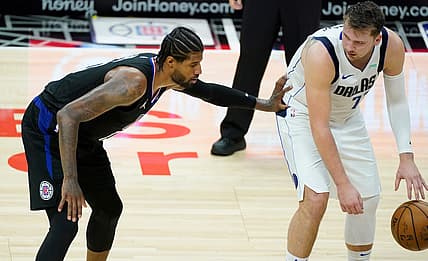 May 25, 2021; Los Angeles, California, USA; LA Clippers guard Paul George (13) defends Dallas Mavericks guard Luka Doncic (77) during the fourth quarter of game two in the first round of the 2021 NBA Playoffs at Staples Center. Mandatory Credit: Robert Hanashiro-USA TODAY Sports