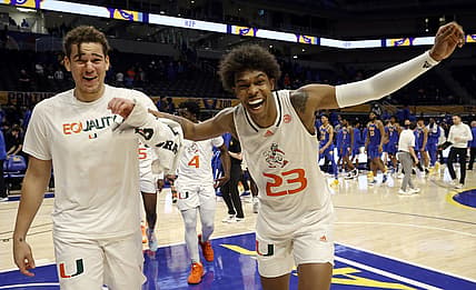 Feb 22, 2022; Pittsburgh, Pennsylvania, USA;  Miami (Fl) Hurricanes forward Thomas Oosterbroek (left) and guard Kameron McGusty (23) celebrate after defeating the Pittsburgh Panthers at the Petersen Events Center. Mandatory Credit: Charles LeClaire-USA TODAY Sports