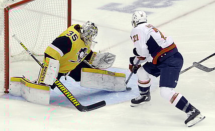 Feb 16, 2021; Pittsburgh, Pennsylvania, USA;  Pittsburgh Penguins goaltender Tristan Jarry (35) makes a save against Washington Capitals right wing Garnet Hathaway (21) during the first period at PPG Paints Arena. Mandatory Credit: Charles LeClaire-USA TODAY Sports