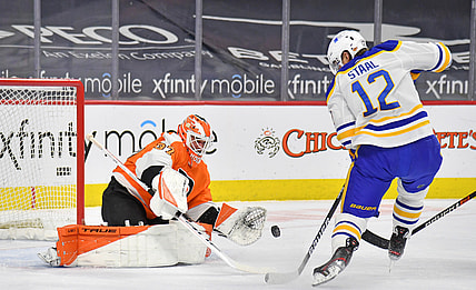 Mar 9, 2021; Philadelphia, Pennsylvania, USA; Philadelphia Flyers goaltender Brian Elliott (37) makes a save as Buffalo Sabres center Eric Staal (12) tries to control the rebound during the second period at Wells Fargo Center. Mandatory Credit: Eric Hartline-USA TODAY Sports