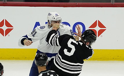Apr 27, 2021; Chicago, Illinois, USA; Tampa Bay Lightning defenseman Erik Cernak (81) and Chicago Blackhawks defenseman Connor Murphy (5) fight during the second period at United Center. Mandatory Credit: David Banks-USA TODAY Sports