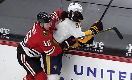 Apr 21, 2021; Chicago, Illinois, USA; Chicago Blackhawks defenseman Nikita Zadorov (16) checks Nashville Predators center Ryan Johansen (92) during the second period at the United Center. Mandatory Credit: Mike Dinovo-USA TODAY Sports