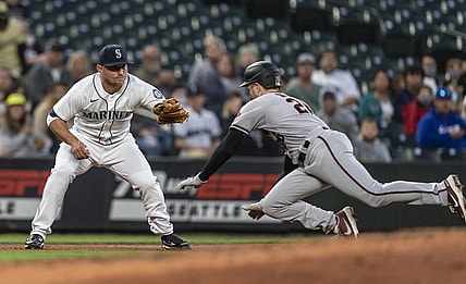 Sep 11, 2021; Seattle, Washington, USA;  Seattle Mariners third baseman Kyle Seager (15) tags out Arizona Diamondbacks first baseman Pavin Smith (26) after Smith tagged up on a fly ball during the fourth inning at T-Mobile Park. Mandatory Credit: Stephen Brashear-USA TODAY Sports