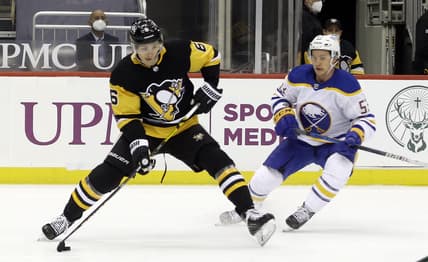 Mar 24, 2021; Pittsburgh, Pennsylvania, USA; Pittsburgh Penguins defenseman John Marino (6) handles the puck against Buffalo Sabres left wing Jeff Skinner (53) during the first period at PPG Paints Arena. Mandatory Credit: Charles LeClaire-USA TODAY Sports