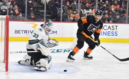 Jan 8, 2022; Philadelphia, Pennsylvania, USA; San Jose Sharks goaltender Adin Hill (33) makes a save as Philadelphia Flyers center Scott Laughton (21) looks on during the second period at Wells Fargo Center. Mandatory Credit: Eric Hartline-USA TODAY Sports