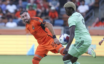 May 27, 2023; Houston, Texas, USA; Houston Dynamo FC midfielder Hector Herrera (16) and Austin FC forward Gyasi Zardes (9) battle for the ball during the first half at Shell Energy Stadium. Mandatory Credit: Troy Taormina-USA TODAY Sports