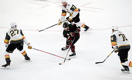 Jan 22, 2021; Glendale, Arizona, USA; Arizona Coyotes right wing Conor Garland (83) skates against Vegas Golden Knights defenseman Shea Theodore (27) and defenseman Alex Pietrangelo (7) and right wing Ryan Reaves (75) during the second period at Gila River Arena. Mandatory Credit: Joe Camporeale-USA TODAY Sports