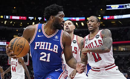 Oct 29, 2022; Chicago, Illinois, USA; Philadelphia 76ers center Joel Embiid (21) is defended by Chicago Bulls forward DeMar DeRozan (11) during the second half at United Center. Mandatory Credit: David Banks-USA TODAY Sports
