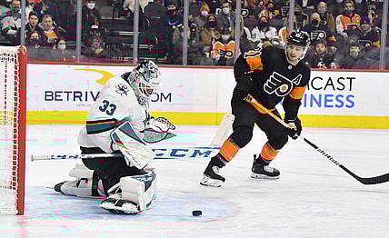 Jan 8, 2022; Philadelphia, Pennsylvania, USA; San Jose Sharks goaltender Adin Hill (33) makes a save as Philadelphia Flyers center Scott Laughton (21) looks on during the second period at Wells Fargo Center. Mandatory Credit: Eric Hartline-USA TODAY Sports