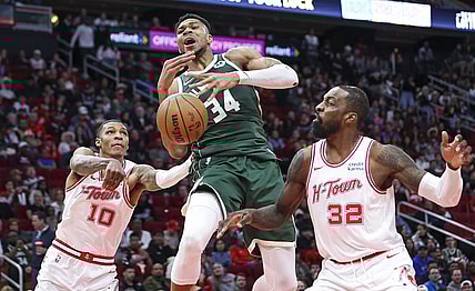 Jan 6, 2024; Houston, Texas, USA; Milwaukee Bucks forward Giannis Antetokounmpo (34) attempts to control the ball as Houston Rockets forward Jabari Smith Jr. (10) defends during the second quarter at Toyota Center. Mandatory Credit: Troy Taormina-USA TODAY Sports