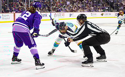 New York Sirens rookie center Casey O'Brien takes a faceoff against Minnesota Frost alternate captain Kelly Pannek.
