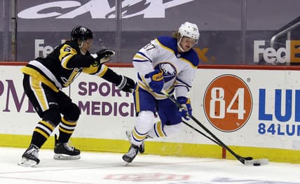May 8, 2021; Pittsburgh, Pennsylvania, USA;  Buffalo Sabres center Casey Mittelstadt (37) moves the puck against Pittsburgh Penguins defenseman John Marino (6) during the second period at PPG Paints Arena. Mandatory Credit: Charles LeClaire-USA TODAY Sports
