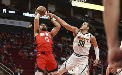Feb 28, 2023; Houston, Texas, USA; Houston Rockets guard Daishen Nix (15) shoots the ball as Denver Nuggets forward Aaron Gordon (50) defends during the first quarter at Toyota Center. Mandatory Credit: Troy Taormina-USA TODAY Sports