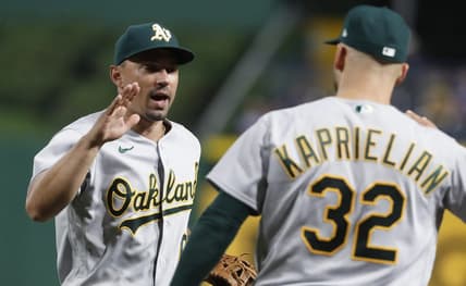 Jun 6, 2023; Pittsburgh, Pennsylvania, USA; Oakland Athletics second baseman Jace Peterson (left) and starting pitcher James Kaprielian (32) celebrate after defeating the Pittsburgh Pirates at PNC Park. Oakland won 11-2.  Mandatory Credit: Charles LeClaire-USA TODAY Sports