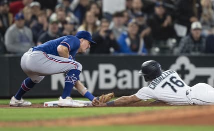 Sep 28, 2023; Seattle, Washington, USA; Texas Rangers third baseman Josh Jung (6) tags out Seattle Mariners second baseman Jose Caballero (76) after Caballero tried to reach third base on a single by shortstop J.P. Crawford (3) during the fifth inning at T-Mobile Park. Mandatory Credit: Stephen Brashear-USA TODAY Sports