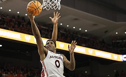 Jan 7, 2023; Auburn, Alabama, USA;  Auburn Tigers guard K.D. Johnson (0) drives for a layup against the Arkansas Razorbacks during the second half at Neville Arena. Mandatory Credit: John Reed-USA TODAY Sports