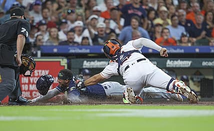 Jul 29, 2023; Houston, Texas, USA; Tampa Bay Rays shortstop Wander Franco (5) is out on a play at home plate as Houston Astros catcher Yainer Diaz (21) applies a tag during the first inning at Minute Maid Park. Mandatory Credit: Troy Taormina-USA TODAY Sports