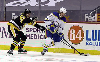 May 8, 2021; Pittsburgh, Pennsylvania, USA;  Buffalo Sabres center Casey Mittelstadt (37) moves the puck against Pittsburgh Penguins defenseman John Marino (6) during the second period at PPG Paints Arena. Mandatory Credit: Charles LeClaire-USA TODAY Sports