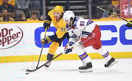 Oct 21, 2021; Nashville, Tennessee, USA; New York Rangers center Mika Zibanejad (93) handles the puck with pressure from Nashville Predators center Matt Duchene (95) during the second period at Bridgestone Arena. Mandatory Credit: Christopher Hanewinckel-USA TODAY Sports