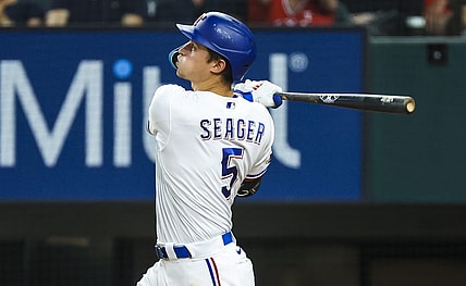 Jul 12, 2022; Arlington, Texas, USA; Texas Rangers shortstop Corey Seager (5) hits a home run during the ninth inning against the Oakland Athletics at Globe Life Field. Mandatory Credit: Kevin Jairaj-USA TODAY Sports