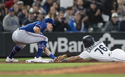 Sep 28, 2023; Seattle, Washington, USA; Texas Rangers third baseman Josh Jung (6) tags out Seattle Mariners second baseman Jose Caballero (76) after Caballero tried to reach third base on a single by shortstop J.P. Crawford (3) during the fifth inning at T-Mobile Park. Mandatory Credit: Stephen Brashear-USA TODAY Sports