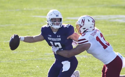 Nov 7, 2020; Evanston, Illinois, USA; Nebraska Cornhuskers linebacker JoJo Domann (13) tries to tackle Northwestern Wildcats quarterback Peyton Ramsey (12) during the second half at Ryan Field. Mandatory Credit: David Banks-USA TODAY Sports