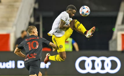Aug 18, 2021; Harrison, New Jersey, USA; Columbus Crew midfielder Kevin Molino (9) tries to controls the ball as New York Red Bulls forward Patryk Klimala (10) defends during the first half  at Red Bull Arena. Mandatory Credit: Vincent Carchietta-USA TODAY Sports