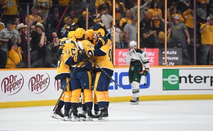 Apr 24, 2022; Nashville, Tennessee, USA; Nashville Predators players celebrate after a goal by defenseman Dante Fabbro (57) during the third period against the Minnesota Wild at Bridgestone Arena. Mandatory Credit: Christopher Hanewinckel-USA TODAY Sports
