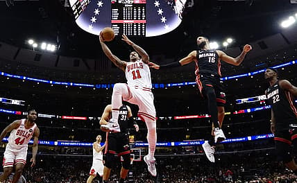 Mar 18, 2023; Chicago, Illinois, USA; Miami Heat forward Caleb Martin (16) defends Chicago Bulls forward DeMar DeRozan (11) during the second half at United Center. Mandatory Credit: David Banks-USA TODAY Sports