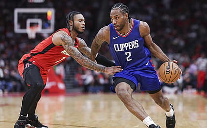 Mar 6, 2024; Houston, Texas, USA; Los Angeles Clippers forward Kawhi Leonard (2) drives with the ball as Houston Rockets forward Cam Whitmore (7) defends during the fourth quarter at Toyota Center. Mandatory Credit: Troy Taormina-USA TODAY Sports