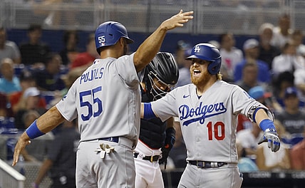 Jul 7, 2021; Miami, Florida, USA; Los Angeles Dodgers third baseman Justin Turner (10) is greeted at the plate by first baseman Albert Pujols (55) after hitting a three run home run during the third inning against the Miami Marlins at loanDepot Park. Mandatory Credit: Rhona Wise-USA TODAY Sports