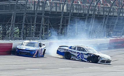 May 13, 2023; Darlington, South Carolina, USA; NASCAR Xfinity Series driver John Hunter Nemechek (20) wrecks as  Kyle Larson (10) drives to the checkered flag during the Xfinity Series Shriners Children   s 200 at Darlington Raceway. Mandatory Credit: David Yeazell-USA TODAY Sports