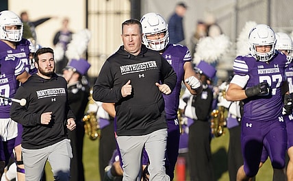 Nov 26, 2022; Evanston, Illinois, USA; Northwestern Wildcats head coach Pat Fitzgerald leads his team on the field against the Illinois Fighting Illini at Ryan Field. Mandatory Credit: David Banks-USA TODAY Sports