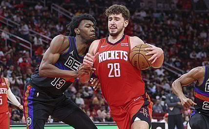 Jan 1, 2024; Houston, Texas, USA; Houston Rockets center Alperen Sengun (28) controls the ball as Detroit Pistons center James Wiseman (13) defends during the game at Toyota Center. Mandatory Credit: Troy Taormina-USA TODAY Sports