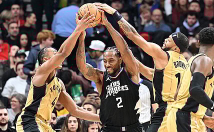 Jan 26, 2024; Toronto, Ontario, CAN;   Los Angeles Clippers forward Kawhi Leonard (2) battles for the ball against Toronto Raptors forward Scottie Barnes (4) and guard Bruce Brown (11) in the first half at Scotiabank Arena. Mandatory Credit: Dan Hamilton-USA TODAY Sports