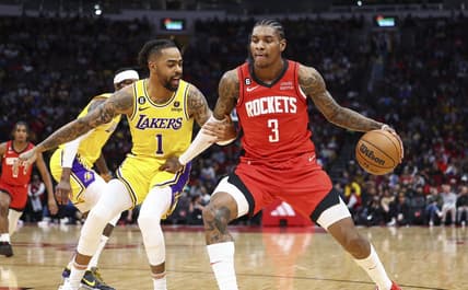 Mar 15, 2023; Houston, Texas, USA; Houston Rockets guard Kevin Porter Jr. (3) controls the ball as Los Angeles Lakers guard D'Angelo Russell (1) defends during the second quarter at Toyota Center. Mandatory Credit: Troy Taormina-USA TODAY Sports