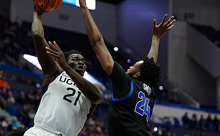 Nov 15, 2022; Hartford, Connecticut, USA; Connecticut Huskies forward Adama Sanogo (21) looks to pass the ball against Buffalo Bulls forward Jonnivius Smith (24) in the first half at XL Center. Mandatory Credit: David Butler II-USA TODAY Sports