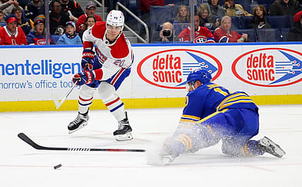 Oct 23, 2023; Buffalo, New York, USA;  Buffalo Sabres defenseman Henri Jokiharju (10) tries to block a shot by Montreal Canadiens left wing Juraj Slafkovsky (20) during the first period at KeyBank Center. Mandatory Credit: Timothy T. Ludwig-USA TODAY Sports