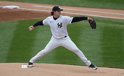 Apr 1, 2021; Bronx, New York, USA; New York Yankees starting pitcher Gerrit Cole (45) pitches against the Toronto Blue Jays during the first inning of an opening day game at Yankee Stadium. Mandatory Credit: Brad Penner-USA TODAY Sports
