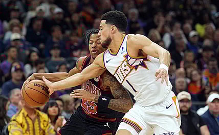 Jan 22, 2024; Phoenix, Arizona, USA; Phoenix Suns guard Devin Booker (1) guards Chicago Bulls forward Dalen Terry (25) during the first half at Footprint Center. Mandatory Credit: Joe Camporeale-USA TODAY Sports