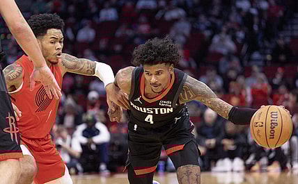 Jan 24, 2024; Houston, Texas, USA; Houston Rockets guard Jalen Green (4) dribbles against Portland Trail Blazers guard Anfernee Simons (1) in the first quarter at Toyota Center. Mandatory Credit: Thomas Shea-USA TODAY Sports