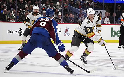 Vegas Golden Knights center Jack Eichel, right, drives down the ice with the puck as Colorado Avalanche defenseman Cale Makar drops back to cover in the second period of an NHL hockey game Wednesday, Nov. 27, 2024, in Denver. (AP Photo/David Zalubowski)