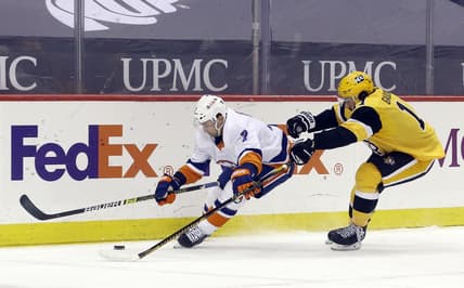 Mar 27, 2021; Pittsburgh, Pennsylvania, USA;  New York Islanders right wing Jordan Eberle (7) moves the puck against pressure rom Pittsburgh Penguins center Frederick Gaudreau (11) during the first period at PPG Paints Arena. Mandatory Credit: Charles LeClaire-USA TODAY Sports